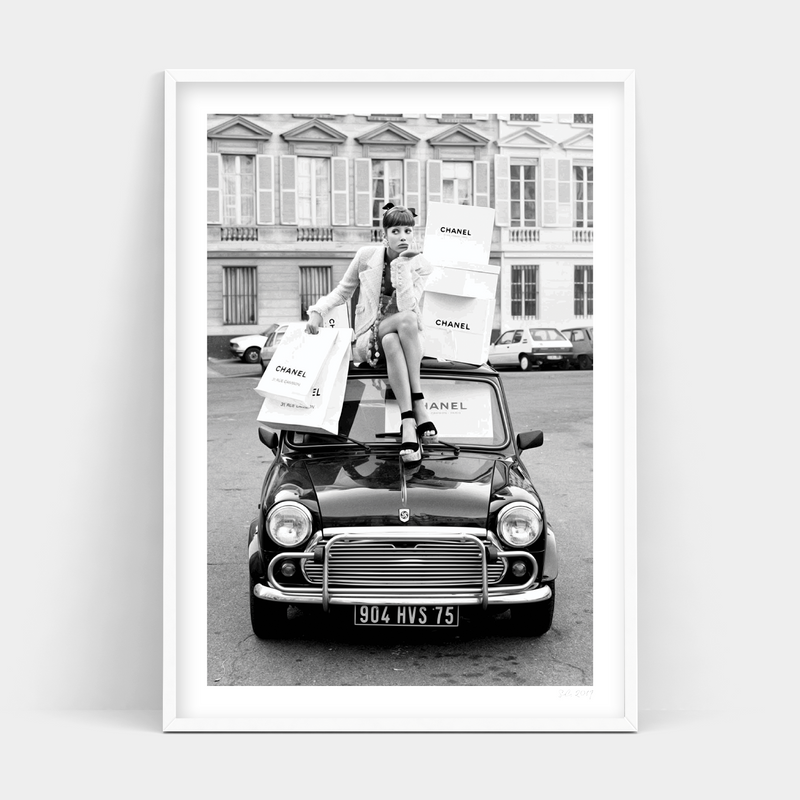 A black and white print of a woman sitting on top of a mini cooper by RETAIL THERAPY, Art Prints.