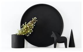 A polished black tray marbled with Concrete Cone - Ink, adorned with flowers and a wooden horse from Zakkia brand.