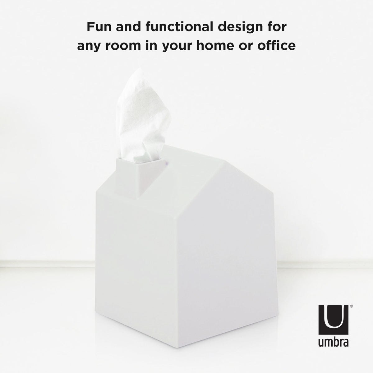 Umbra Casa white tissue box cover on a shelf with a tissue drawn through the chimney