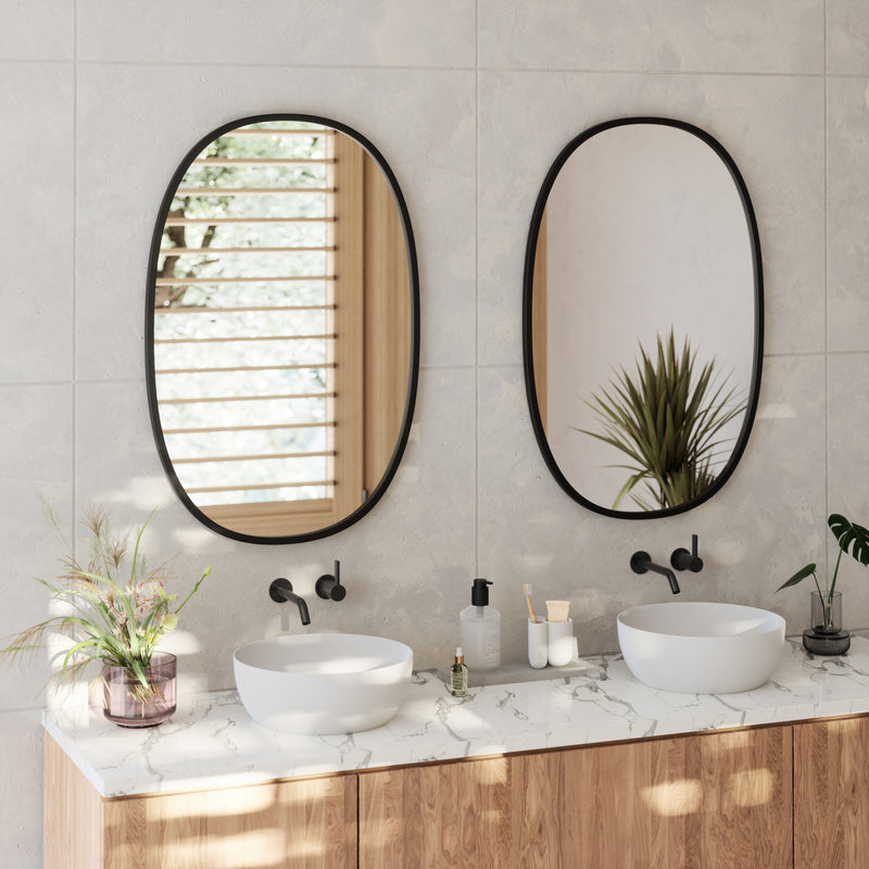 Two Umbra Hub oval mirrors in black above a double vanity with stone benchtop