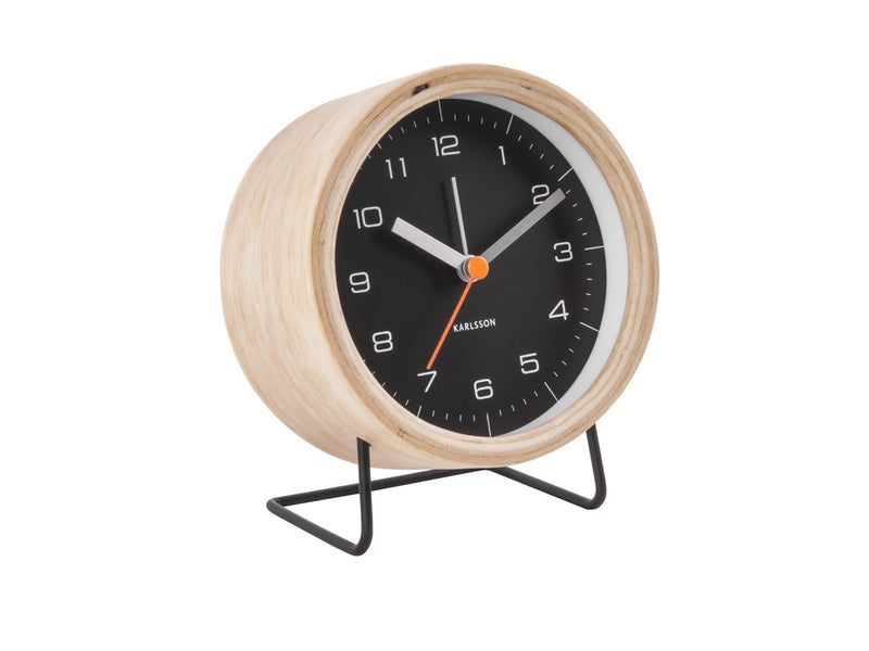 A Karlsson Alarm Innate - Various Colours with a black and white design and wood casing, placed on a stand.
