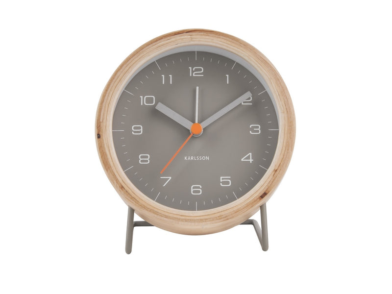 A Karlsson Alarm Innate - Various Colours with a grey and orange wood casing on a stand.