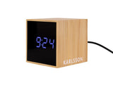 A minimal Scandinavian clock branded as Karlsson, made of wood.