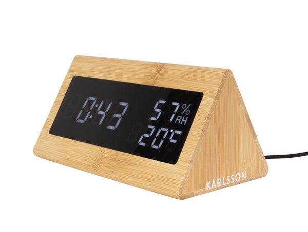 An aesthetic Karlsson Alarm Triangle clock with a minimal design and digital display.