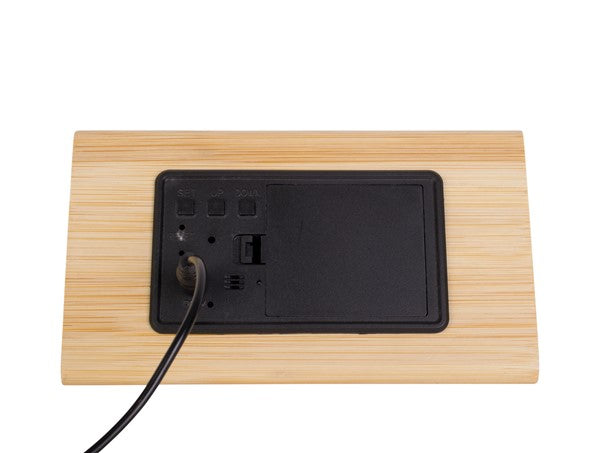 A Scandinavian-designed Karlsson Alarm Triangle stand featuring a phone plugged into it.