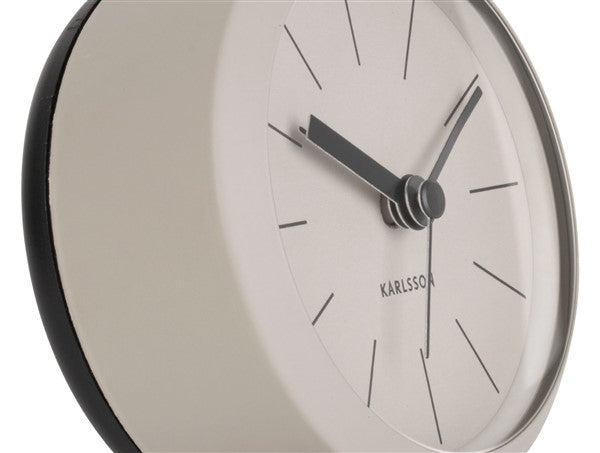Close-up of the warm grey Button alarm clock dial and black hands
