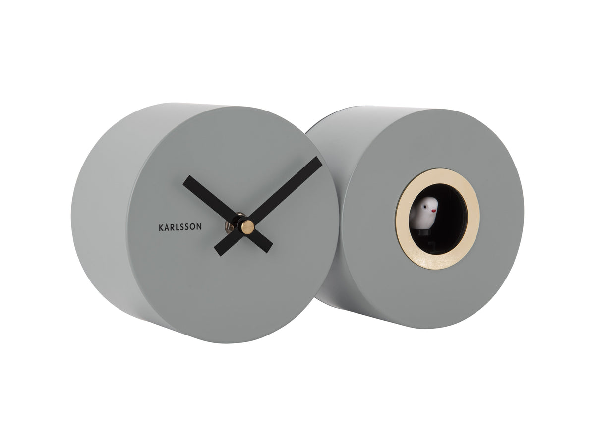 A Karlsson Duo Cuckoo clock with a grey face and a black face.