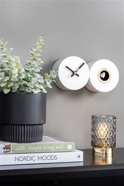 A Karlsson Duo Cuckoo clock on a shelf.