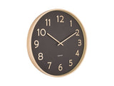 A Pure - Various Options wall clock by Karlsson featuring a sleek black and gold design on a clean white background.