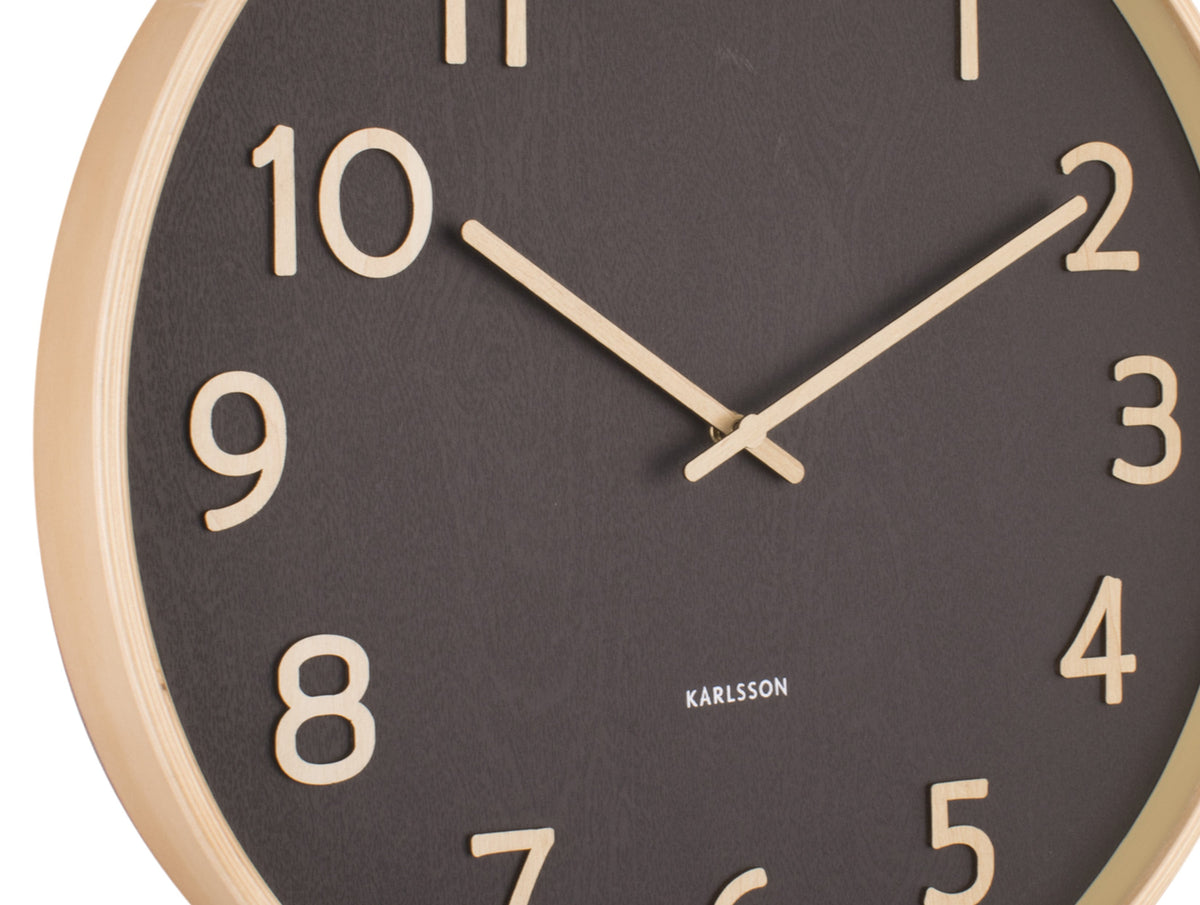 Close-up of the black Karlsson Pure Wall Clock face with light numerals