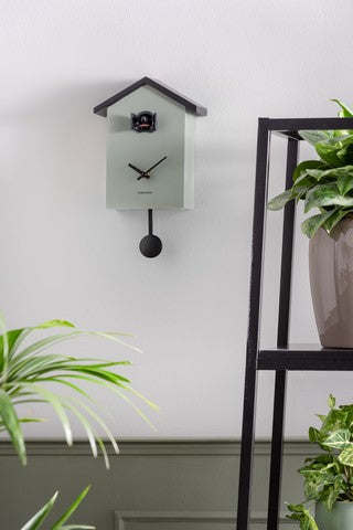 A Karlsson Cuckoo Traditional - Various Options wall clock with a plant on it.