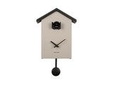 A Cuckoo Traditional - Various Options cuckoo wall clock hanging on a white wall.