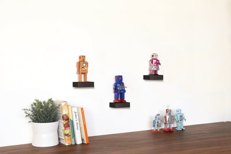 A set of (3) Umbra Showcase Shelves - Black displaying robot figurines from the Umbra range.