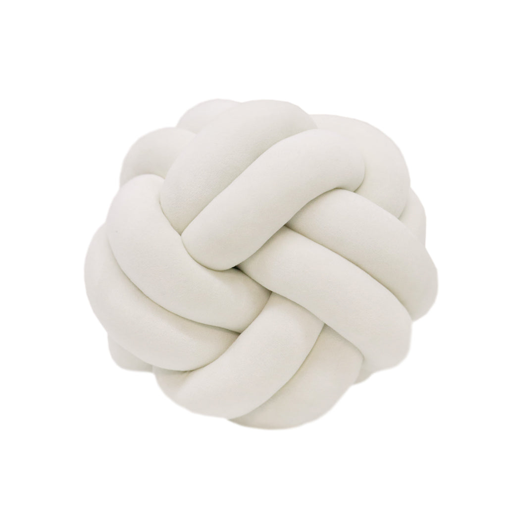 Ivory velvet knot cushion, a soft round cushion tied in a braided knot, on a white background