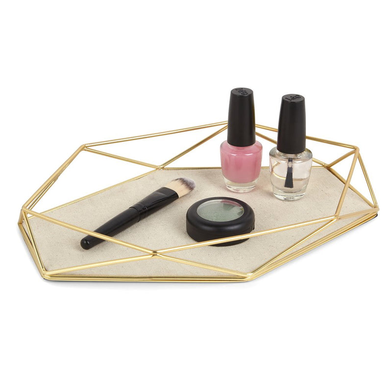 A Prisma Jewellery Tray - Matt Brass in the Umbra range, complete with nail polish and other cosmetics.