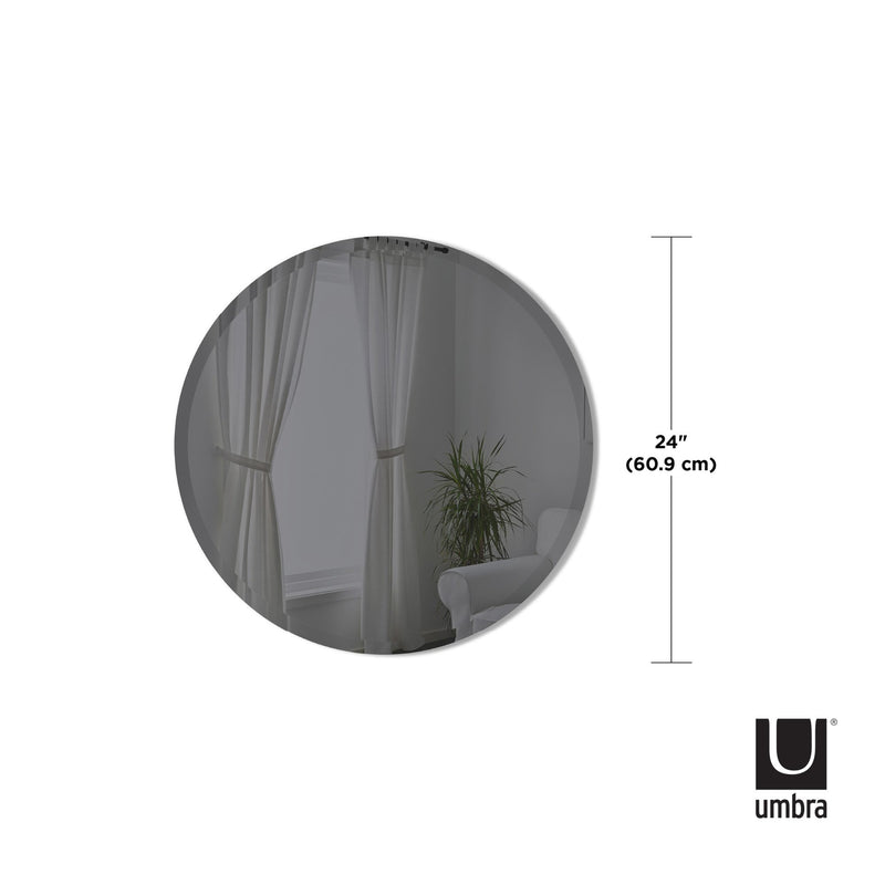 A versatile round mirror from the Umbra range, featuring a Hub Mirror - Bevy 36" - Smoke wall mirror in a room.
