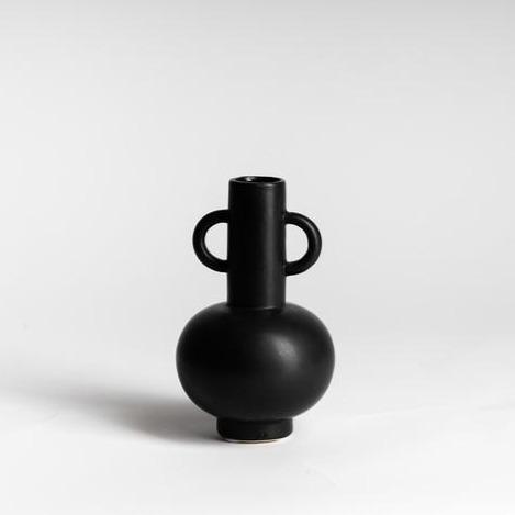 A white surface showcasing a black Ned Collections Louis Vase Black / White.