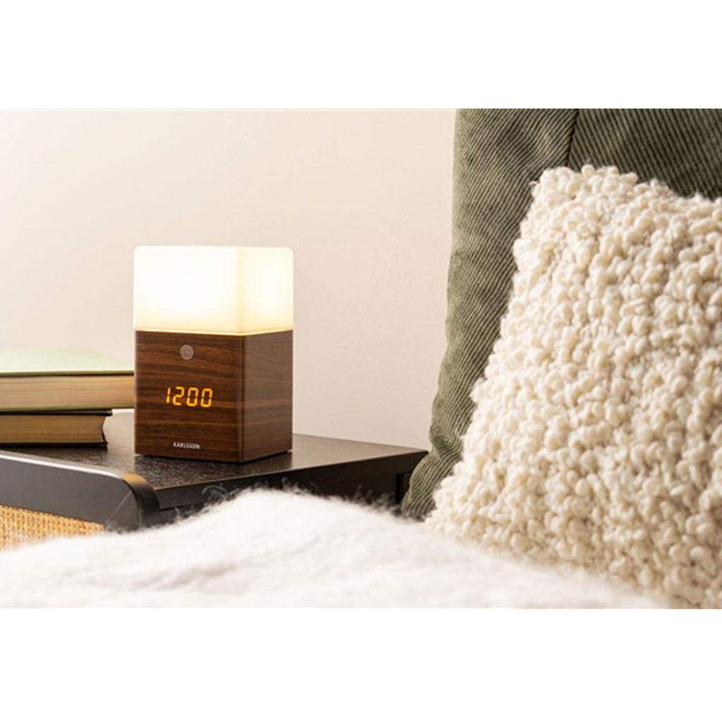 Karlsson Frost Light Alarm Clock illuminated, showing the frosted top glowing