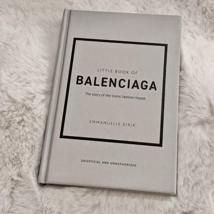 Little Book of Balenciaga styled with a plant on a table