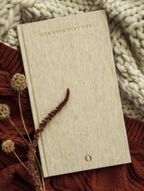 An OPRAH X WRITE TO ME | LIVE YOUR BEST LIFE JOURNAL on top of a knitted blanket.