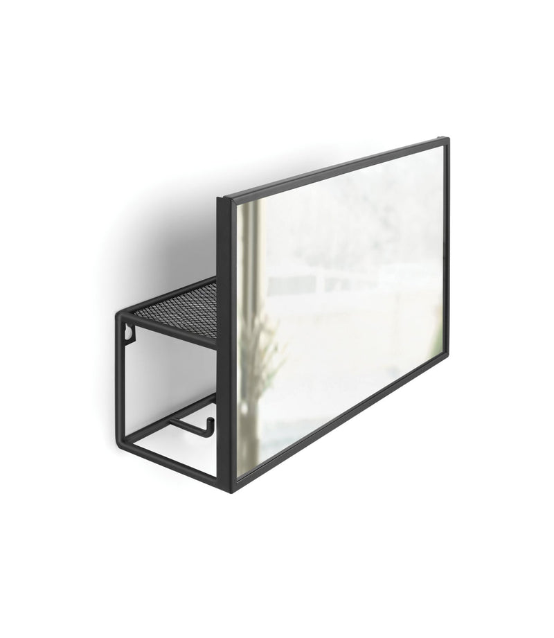 An Umbra Cubiko Mirror & Organizer - Black, the ultimate entryway must-have for small space living, hanging on a wall next to a window.