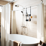 A bathroom with a bathtub featuring a shower curtain and helpful organization tools such as the Umbra Flex Shower Caddy - Black / White.