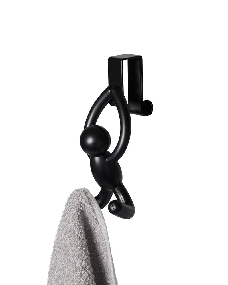 An Umbra Buddy Over the Door Hook Set of 2 with a towel hanging from it.