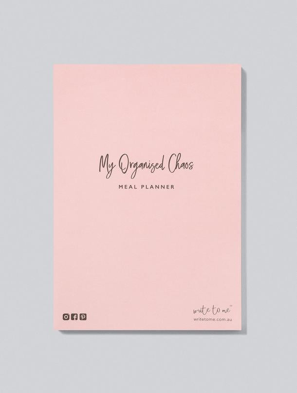 A pink notebook with the words 'Meal Planner • My Organised Chaos' on it by Write To Me.