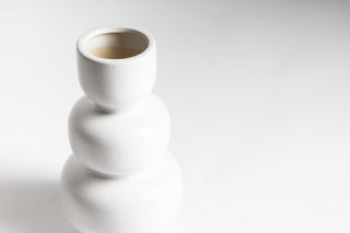 A white Boble vase from Ned Collections on a matte surface.