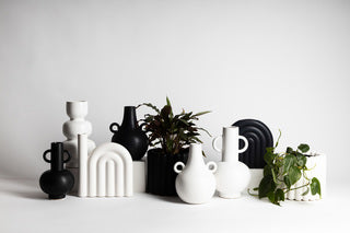 A group of black and white matte finish vases, including a Ned Collections Boble Vase - Black / White, showcased on a clean white surface.