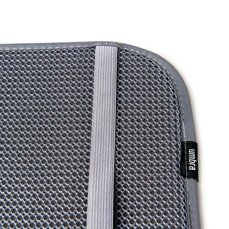 A gray Udry Drying Mat Mini sleeve on a white surface, perfect for compact storage by Umbra.