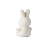 A Miffy Sitting Teddy Cream (33cm) stuffed bunny from Mr Maria sitting on a white surface.