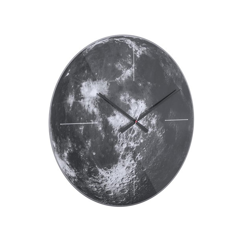 An open face Karlsson black and white wall clock with a moon on it.