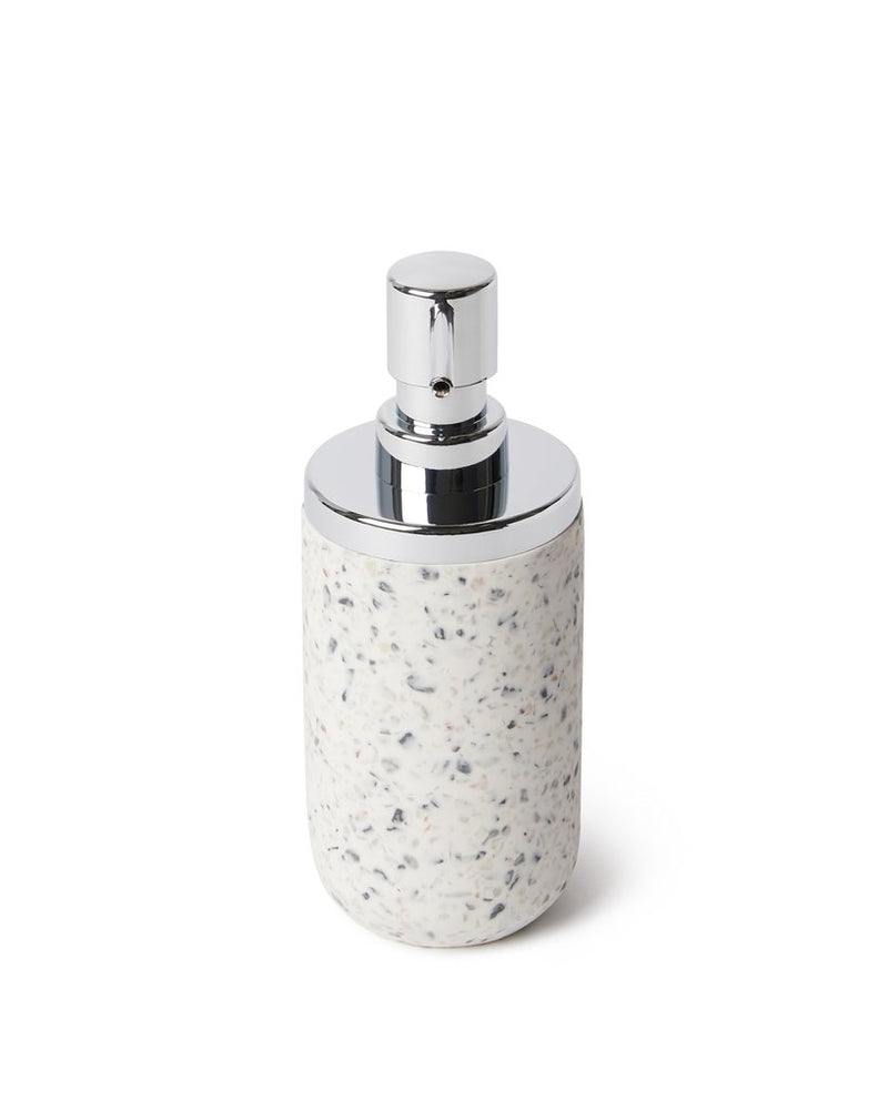 An elegant Terrazzo soap dispenser from the Junip collection by Umbra, placed on a sleek white surface.