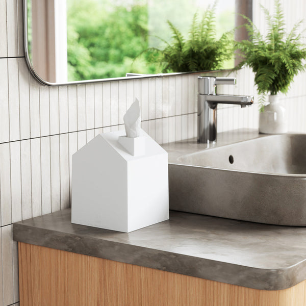A Scandinavian-inspired bathroom featuring a minimalist and aesthetically pleasing sink and an Umbra Casa Tissue Box Cover White.