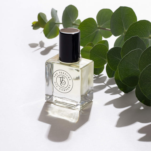 A bottle of LUSH, inspired by Be Delicious (DKNY) fragrance oil from The Perfume Oil Company on a white surface.