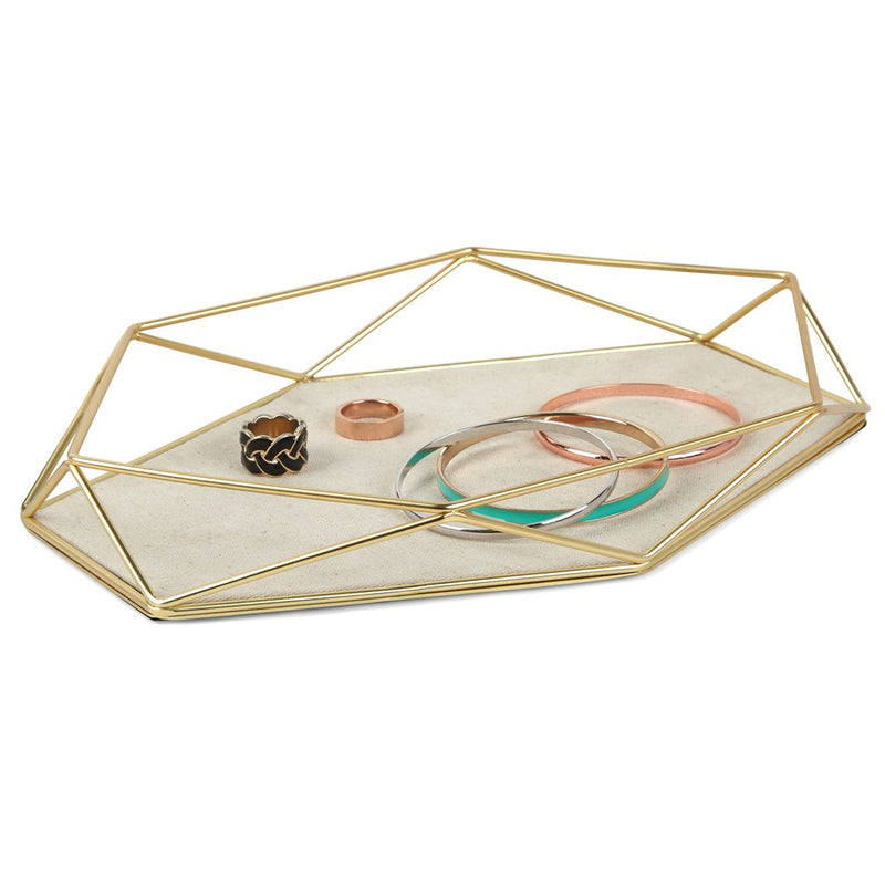 A modern gold tray featuring the Prisma Jewellery Tray - Matt Brass with rings and bangles from the Umbra range.