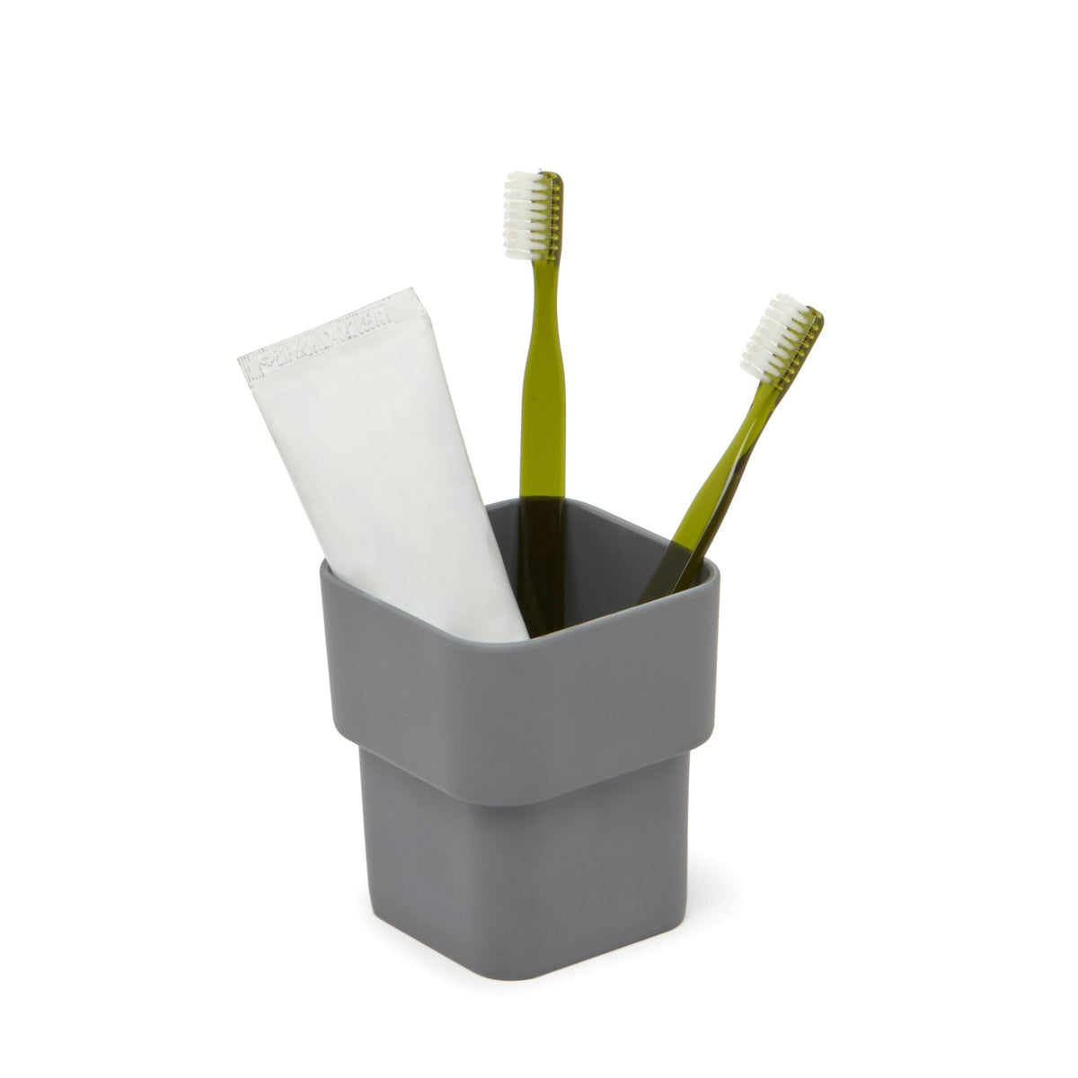 SCILLAE canister in charcoal holding two green toothbrushes and toothpaste, on white