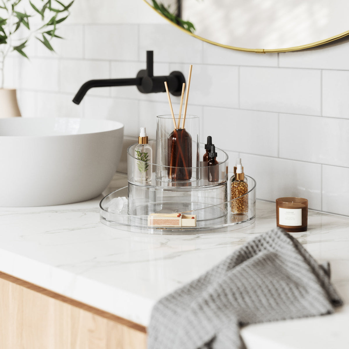 A bathroom with a Umbra CASCADA COSMETIC ORGANIZER and a sink.