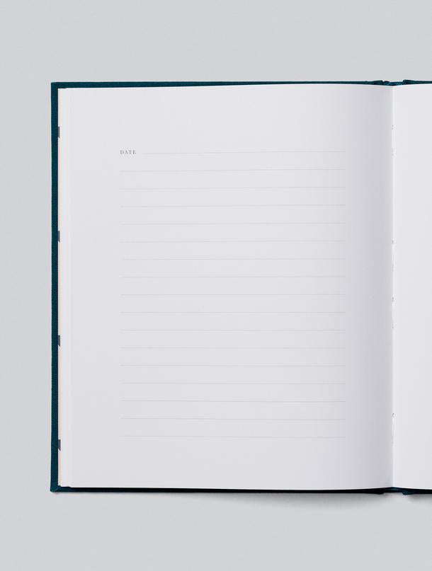 Our Travels journal open to a lined writing page