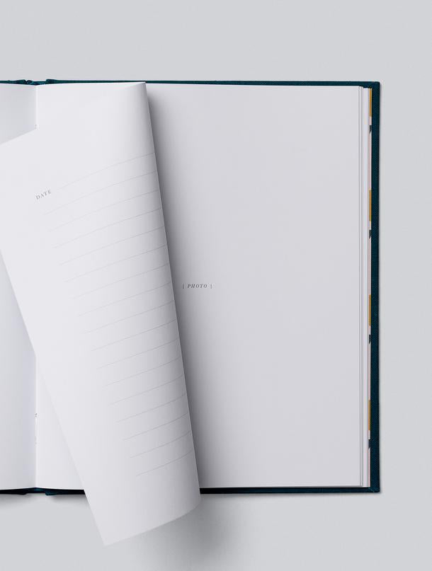 Our Travels journal with pages turning between photo and lined pages