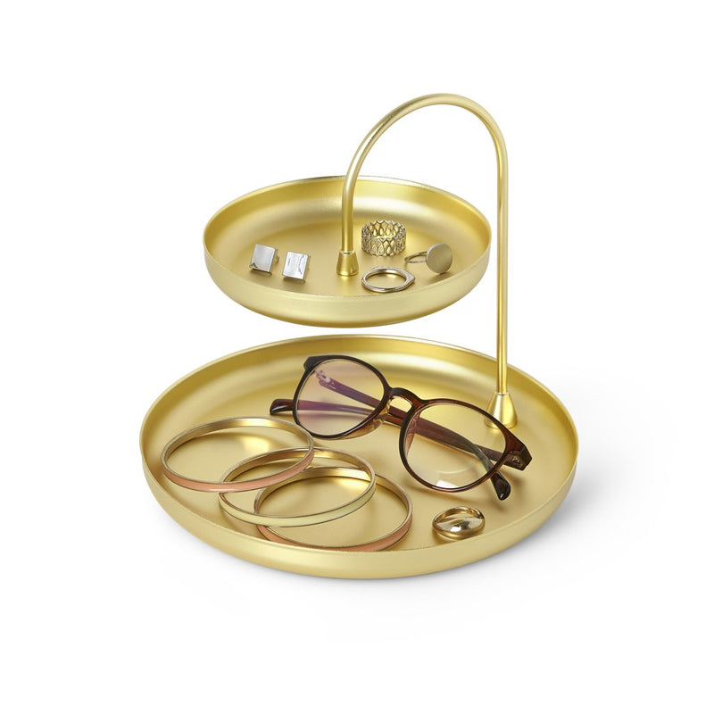A Poise Two Tier Ring Dish Brass adorned with exquisite jewelry, serving as an accessory organizer in the Umbra range.