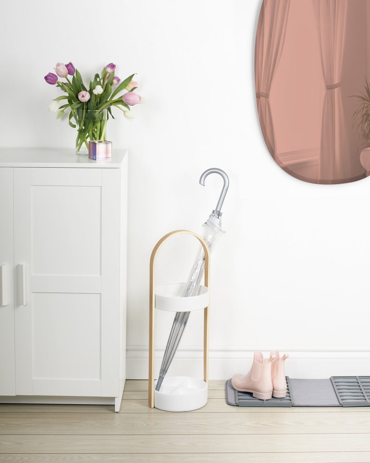 Umbra Bellwood white umbrella stand with wood handle in entryway