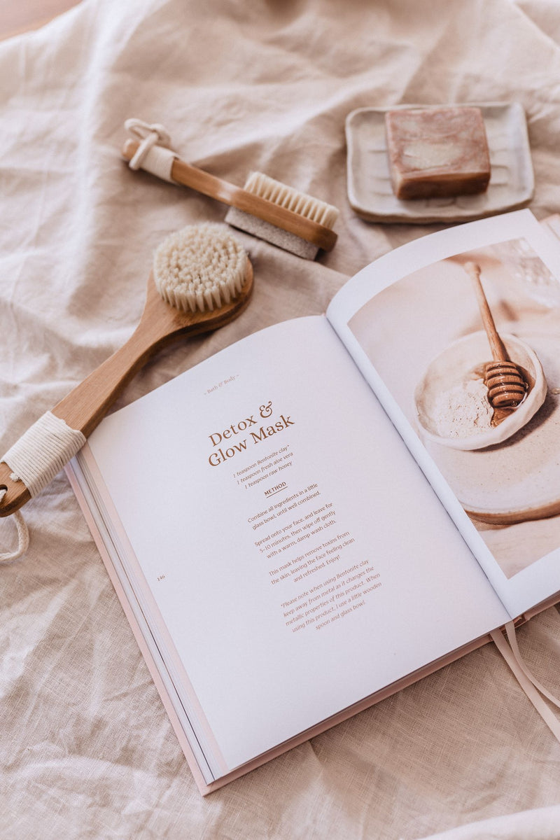 A Healthy Nourished Soul - Book on a bed with self-care items.