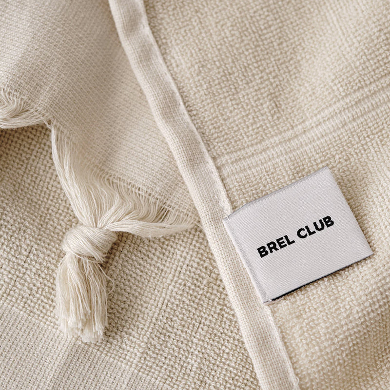 A lightweight Turkish towel with the word Brel Club - Palm Tree on it.