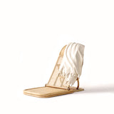 A lightweight rattan chair with a quick-dry TURKISH TOWEL – PALM TREE by Brel Club on it.