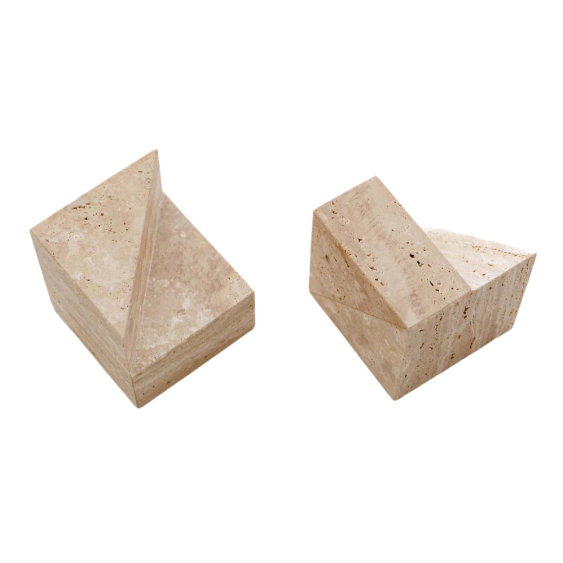 Geometric travertine stone bookends styled on a shelf with linen-bound books