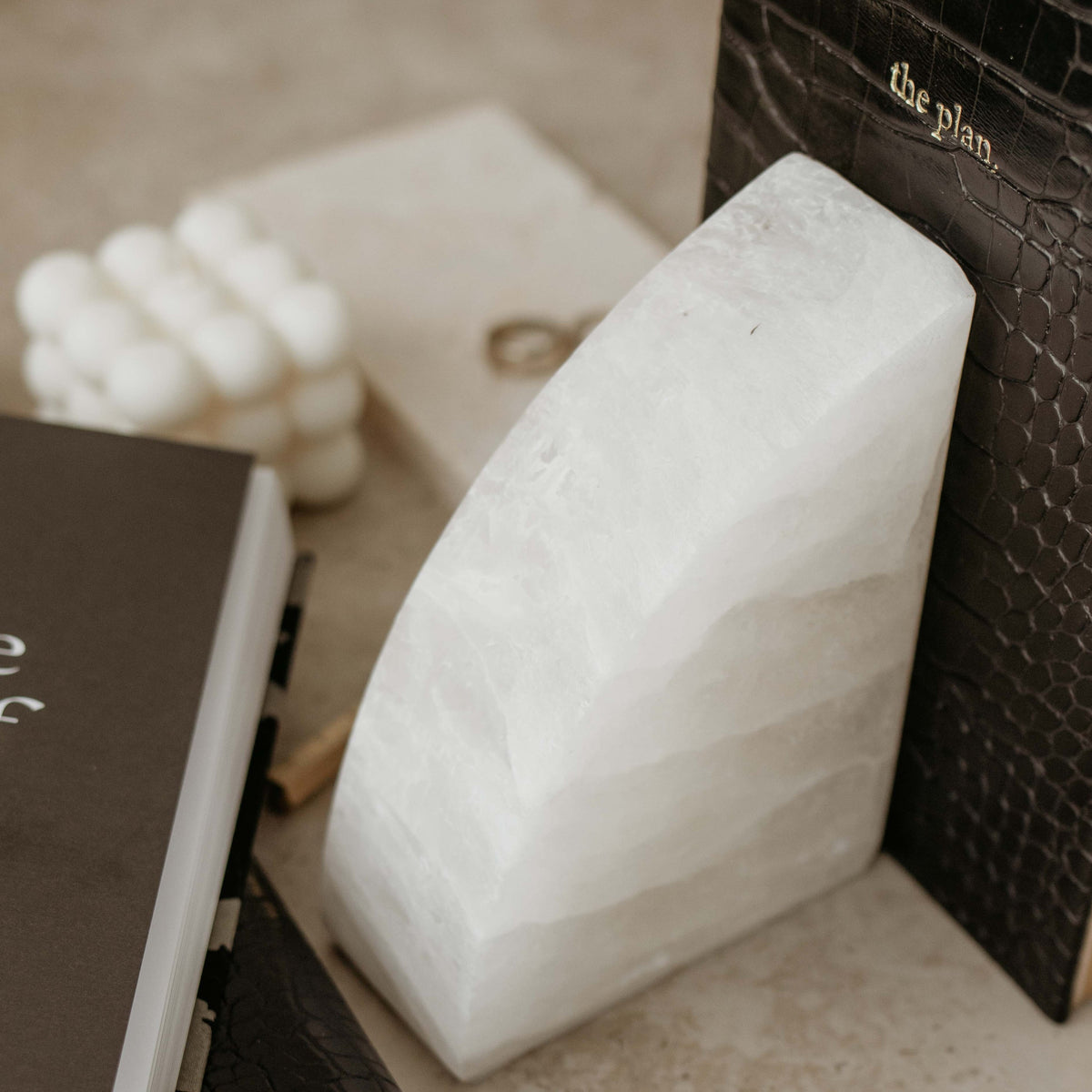 Stone Rounded Bookends from the Papier HQ stationery range are sitting on a table.