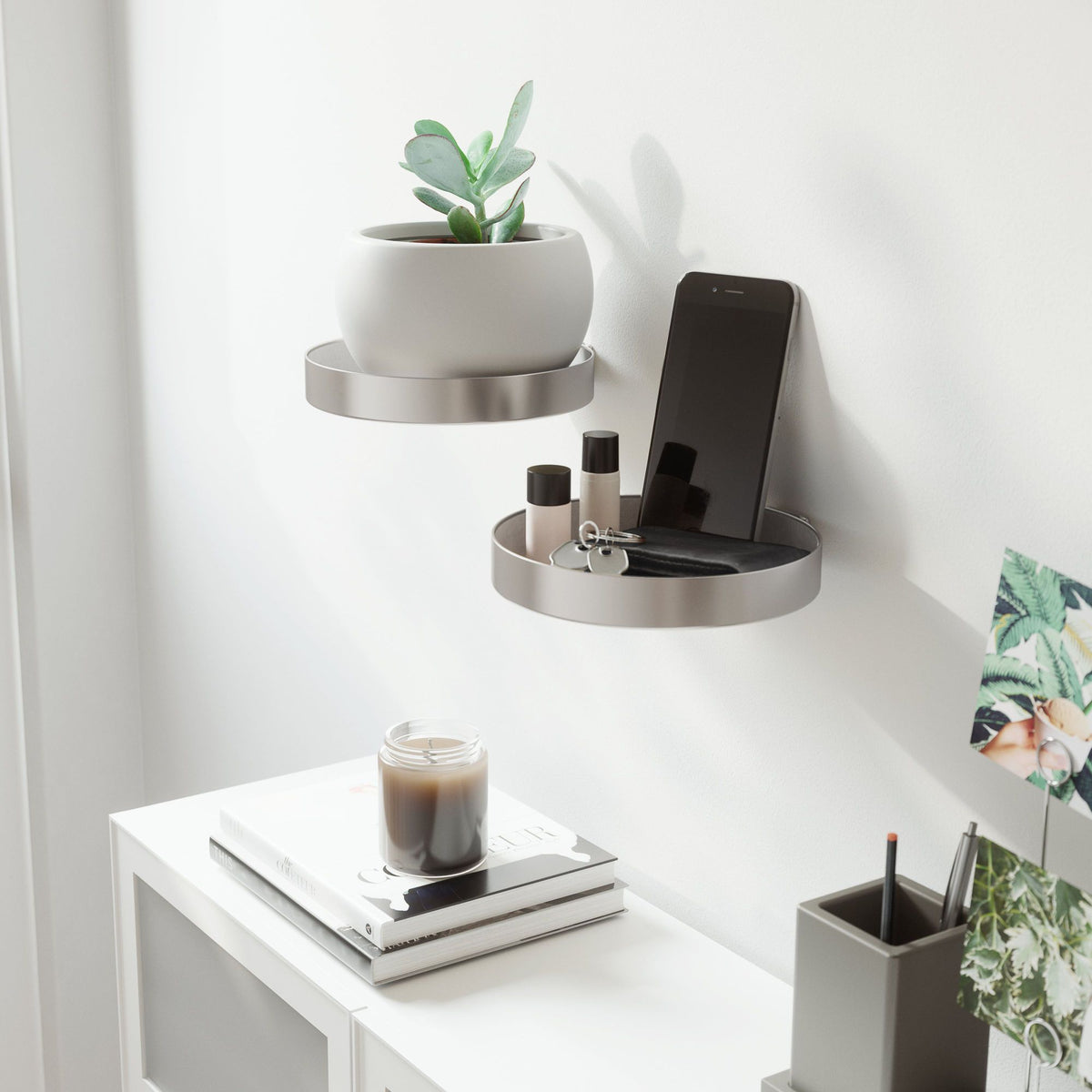 Umbra Perch nickel round wall shelves holding a small plant, phone and trinkets