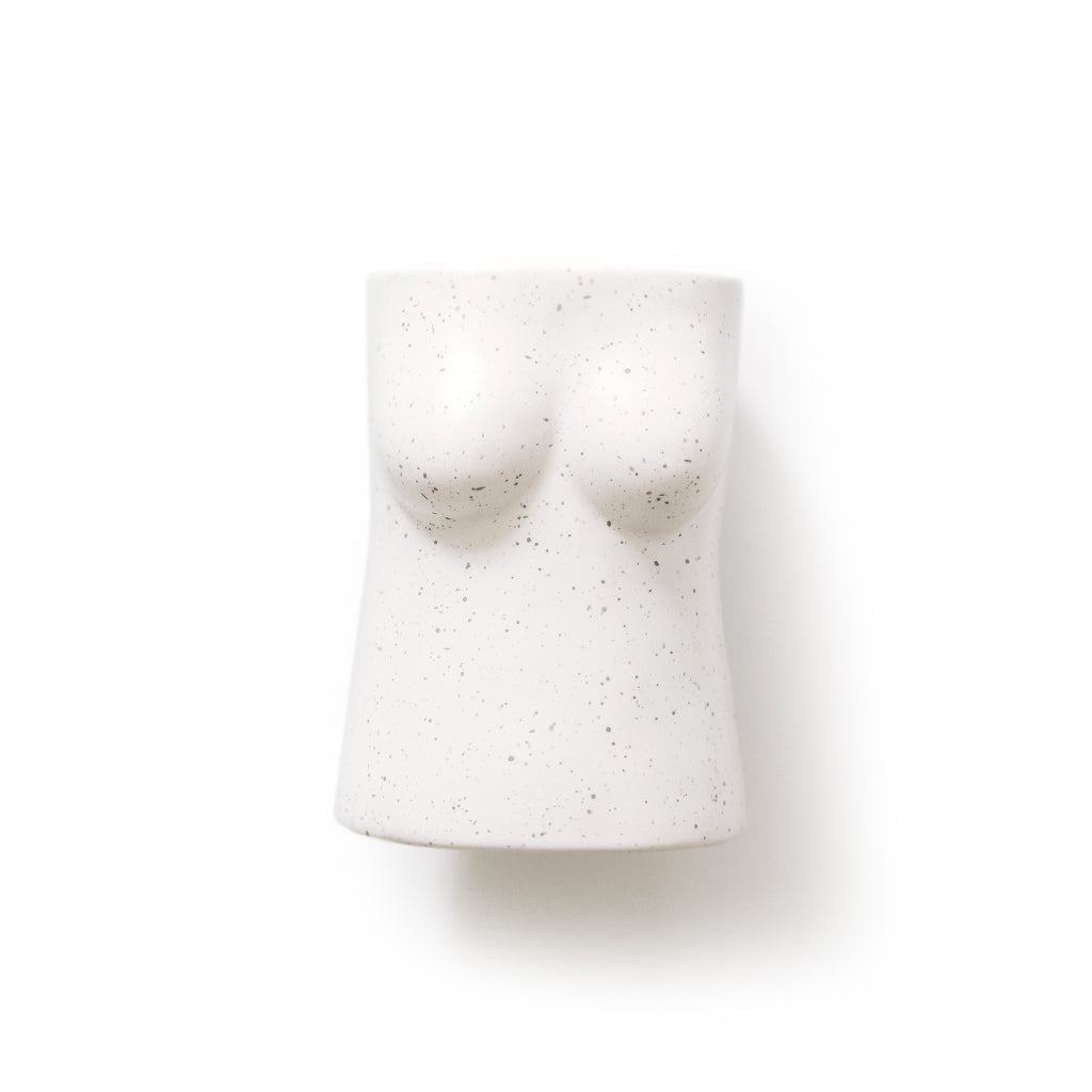 Sculptural ceramic figure pen holder styled on a desk